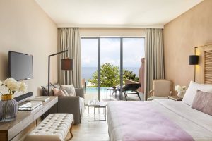 Relaxing Junior Suite with Private Pool, Comfortable Bed, and Scenic Sea View